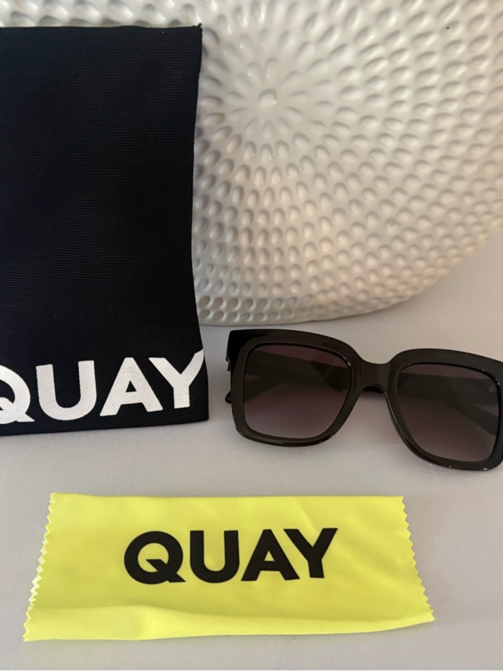 Quay Australia Icy square sunglasses feature oversized black frames.